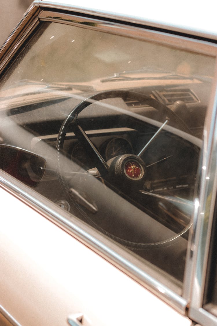 Retro Car Interior With Steering Wheel And Shiny Glass