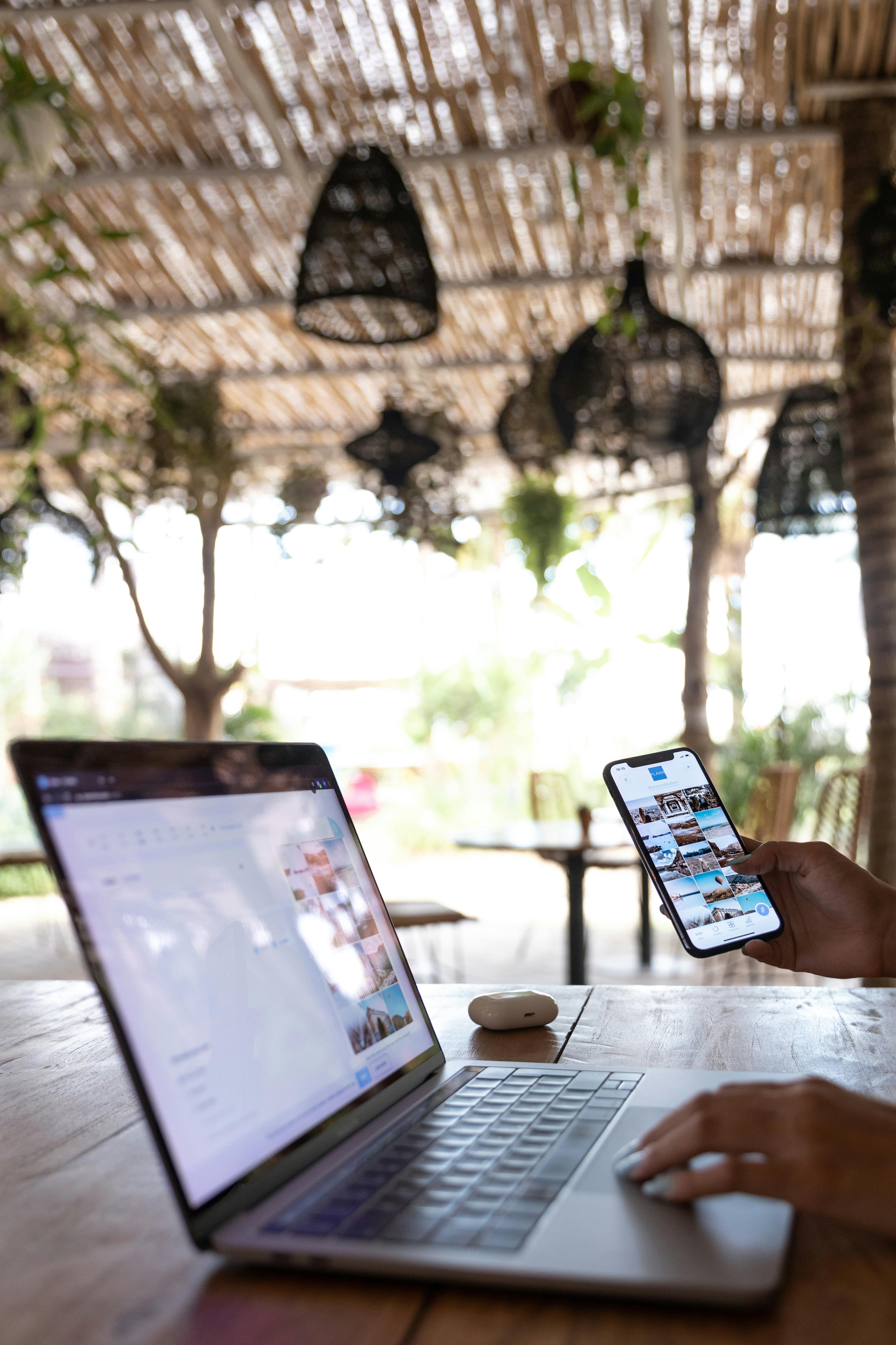 person using laptop and smartphone