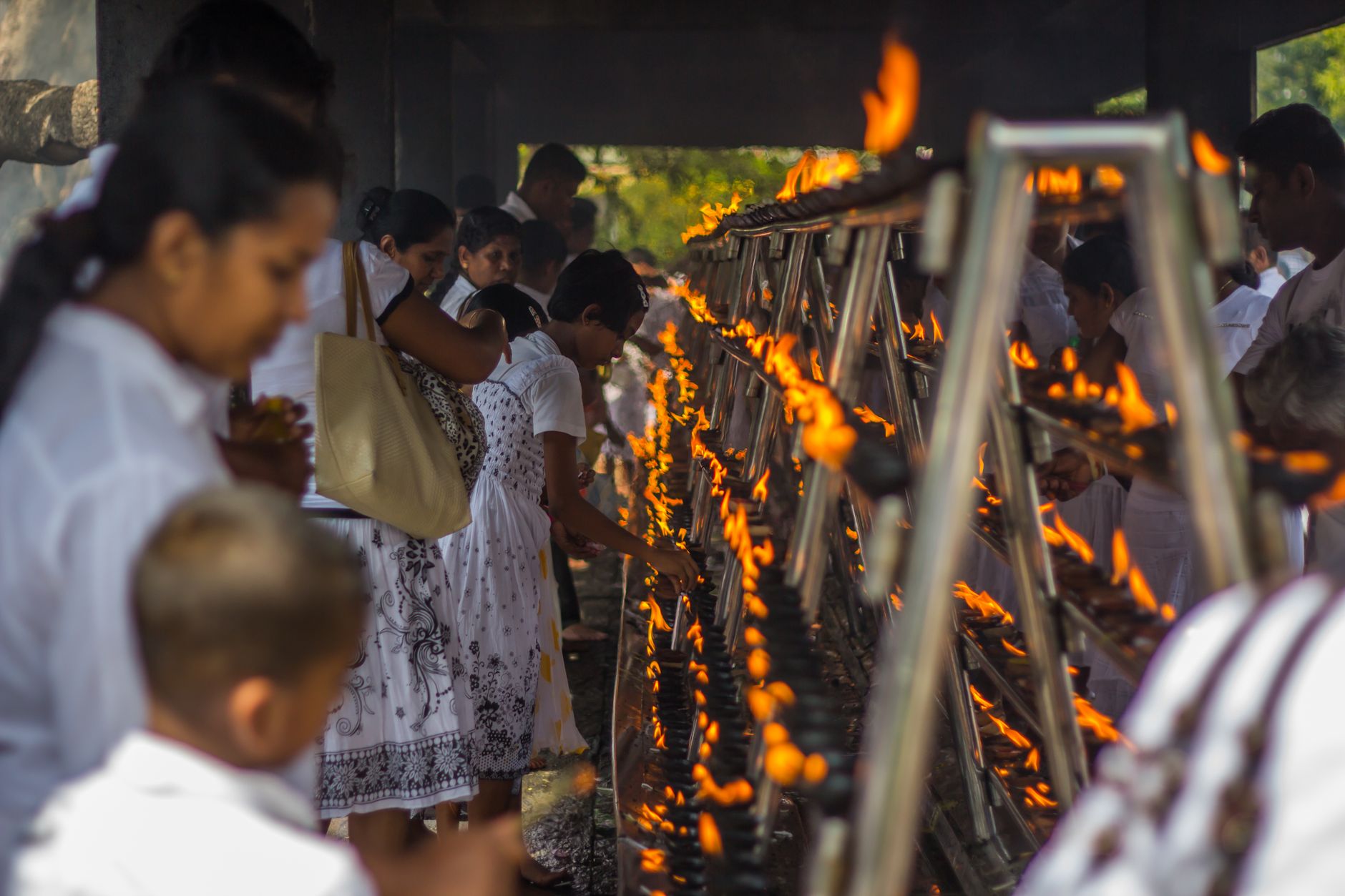 People gathering for a spiritual ritual with lighted candles in Anuradhapura, Sri Lanka.