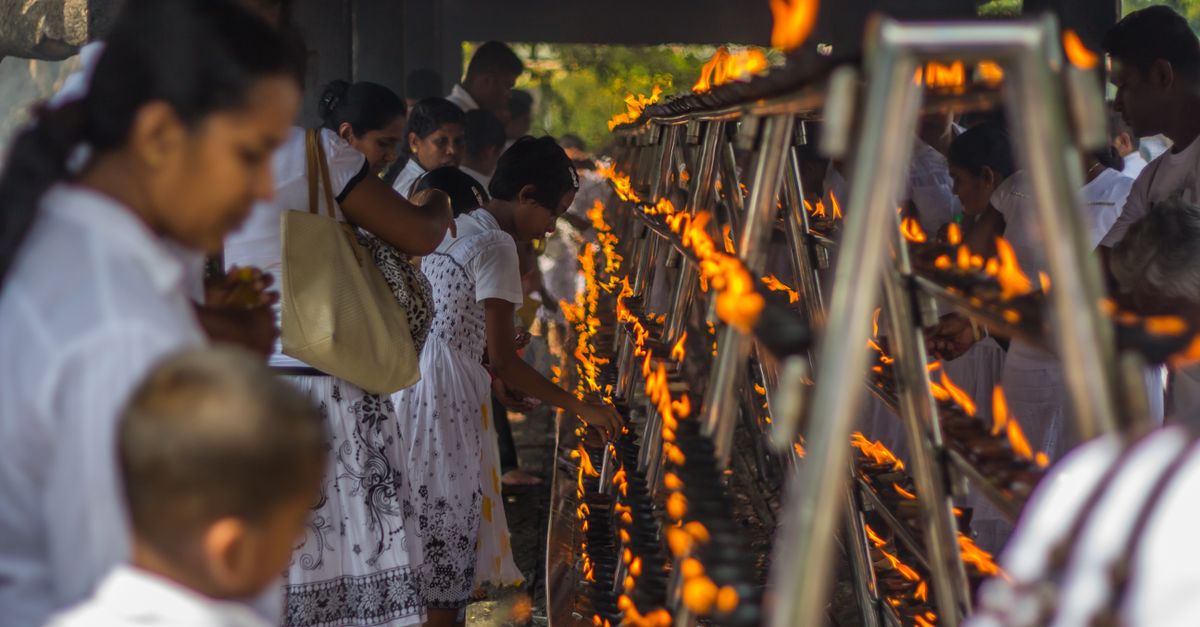Hindu pilgrims at Kataragama temple complex with traditional offerings