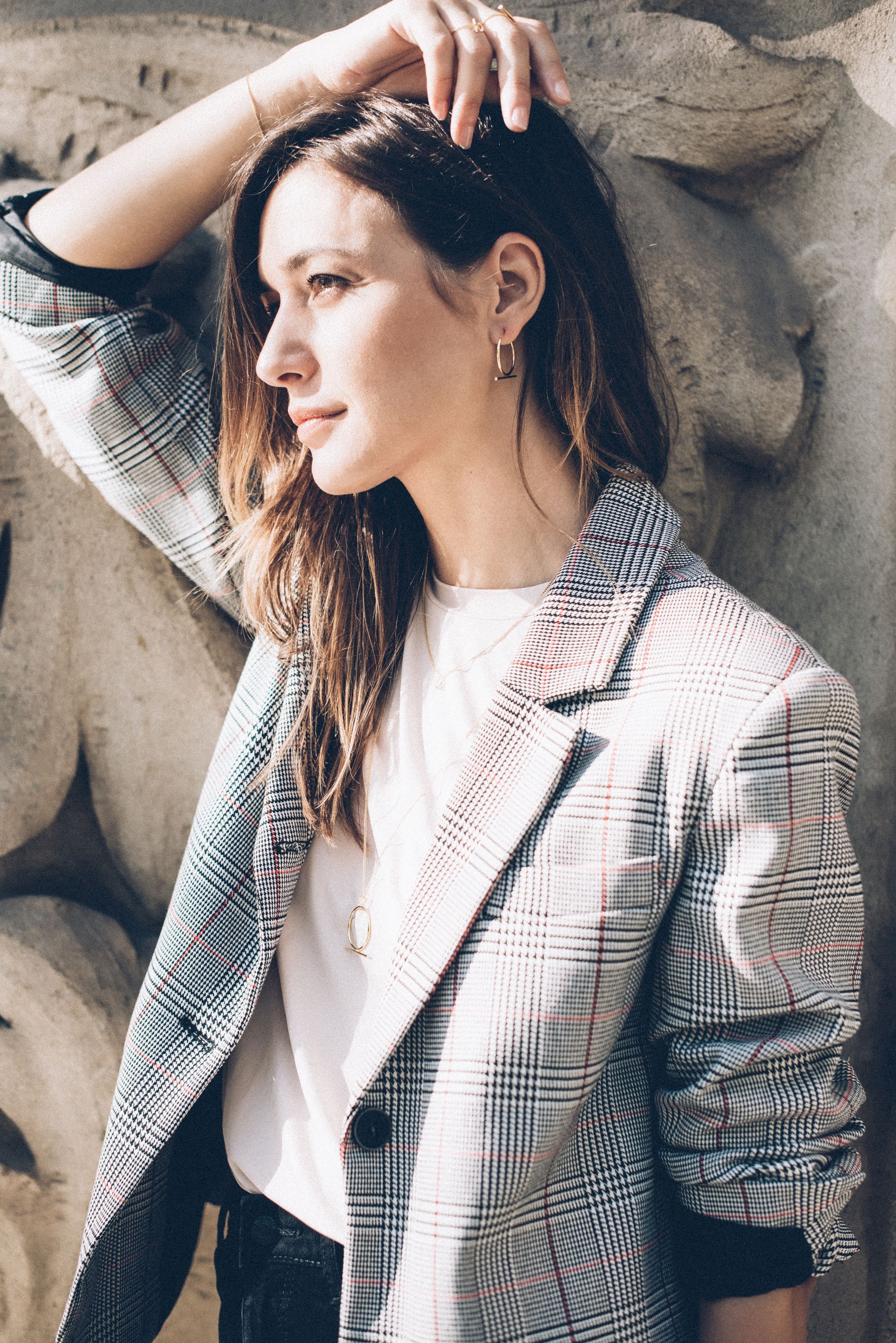 Elegant portrait of a woman in a plaid blazer with modern style