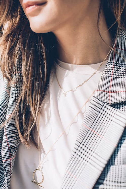 Close-up Shot of a Woman Wearing Silver Necklace 