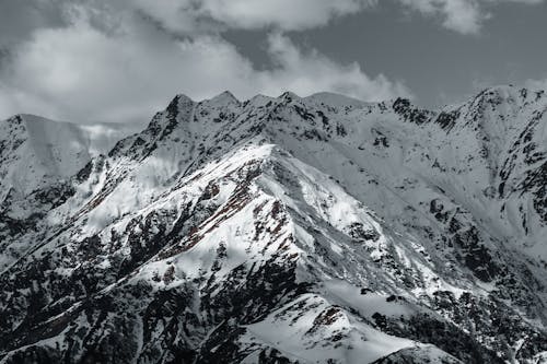 Snow Covered Mountain Under Gray Sky