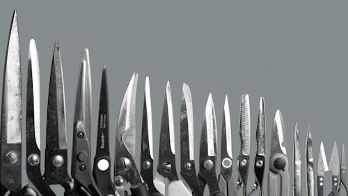 Assorted  Pairs of Scissors on Gray Background