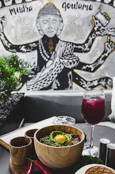 Delicious Buddha bowl with avocado and a refreshing drink in a stylish café setting.