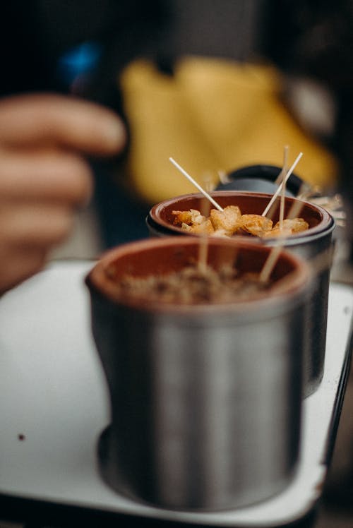 Person Holding Stainless Steel Cup With Brown Liquid