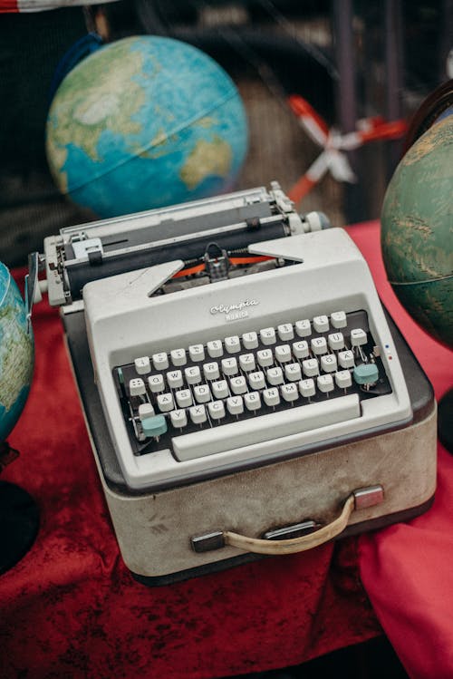 Green and Gray Typewriter on Red Table