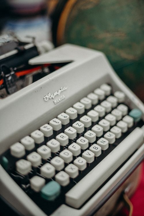 Free Close-up of a vintage Olympia typewriter at a market, showcasing its nostalgic charm. Stock Photo