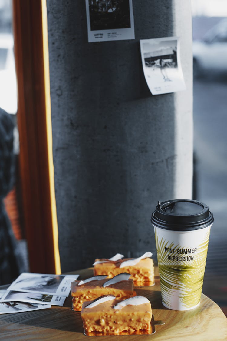 Coffee To Go Served With Glazed Pastries On Cafe Table