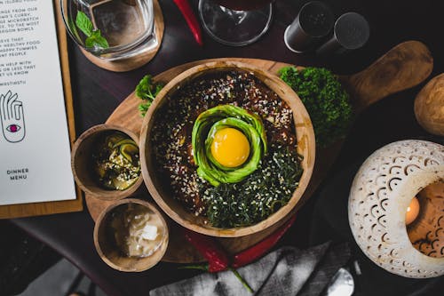 Free Healthy east dish served on wooden cutting board in cafe Stock Photo