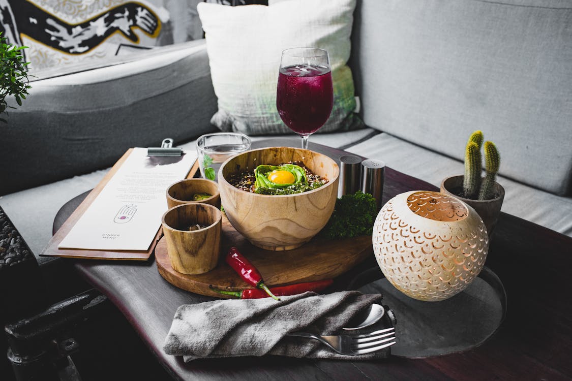 Free Serving of oriental food in wooden dishes with drinks on table of modern cafe Stock Photo
