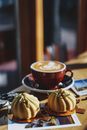 Modern pastries served with cup of cappuccino in cafeteria