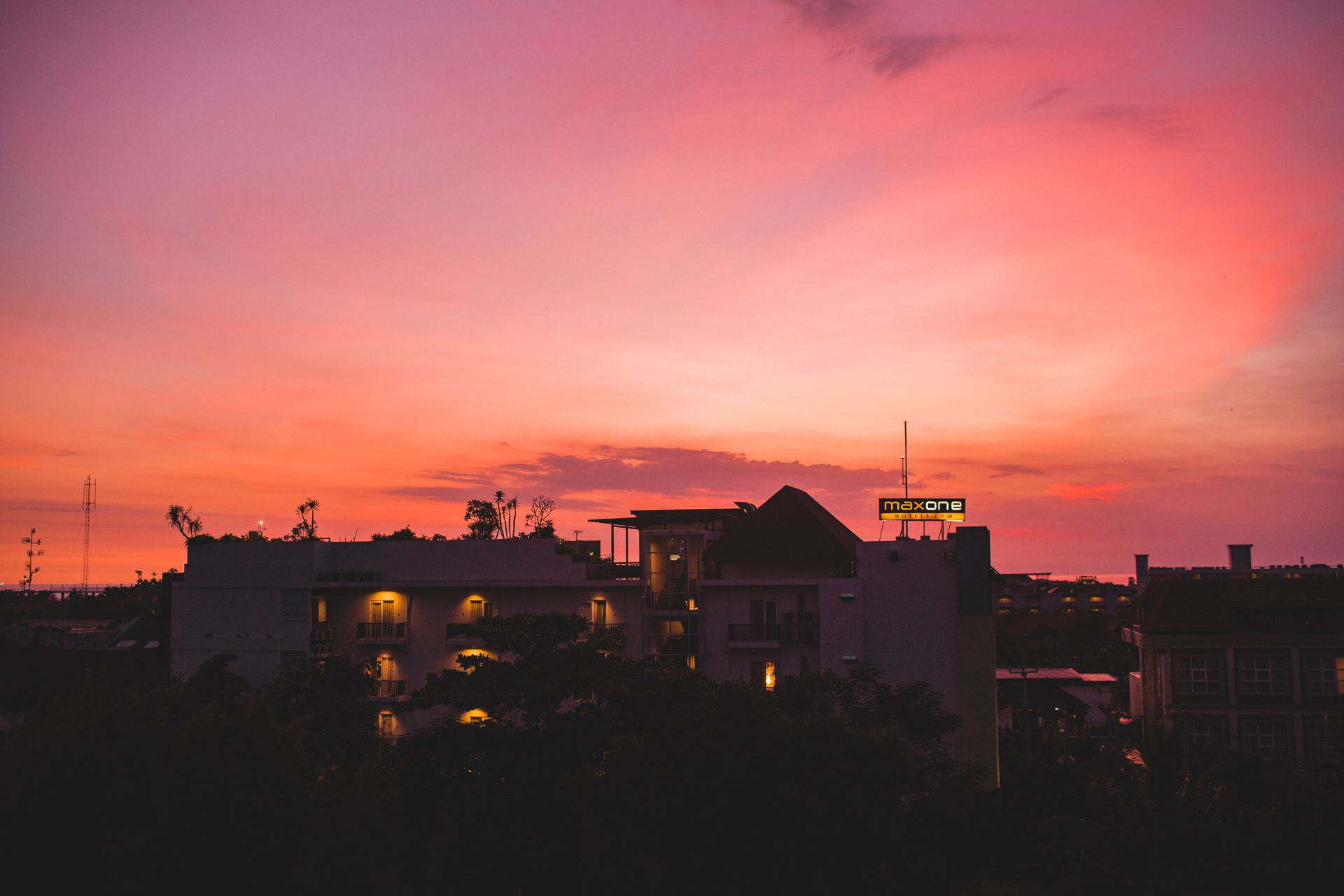 Modern buildings located in resort town against amazing colorful sunset sky on summer day