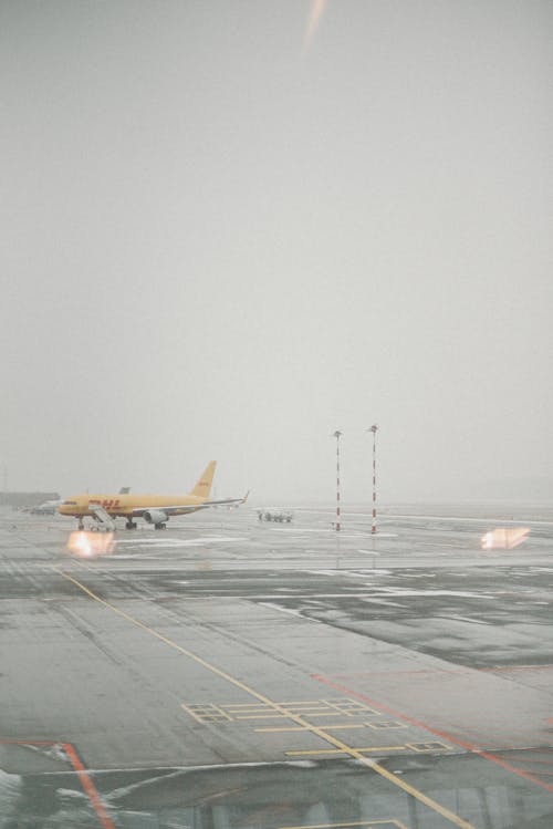 Free Yellow and White Plane on Airport Stock Photo