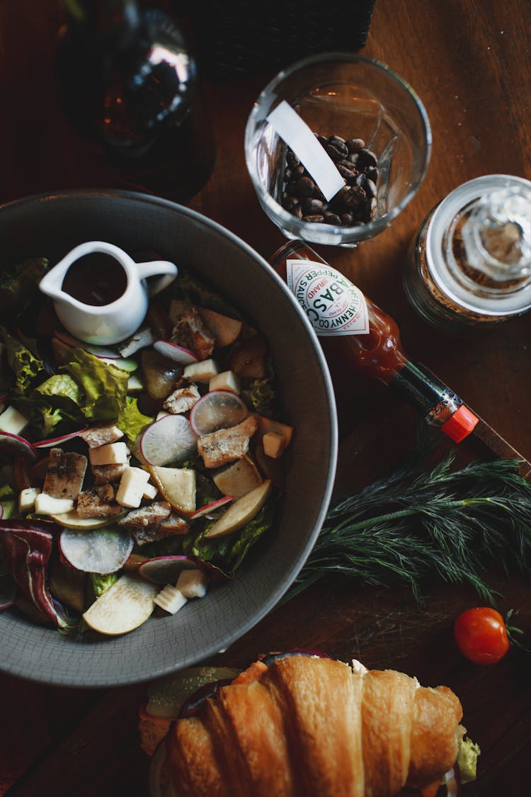 Delicious Salad And Croissant Sandwich On Wooden Table