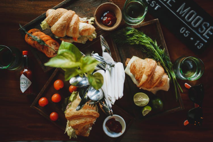 Set Of Appetizing Croissant Sandwiches On Table In Cafe