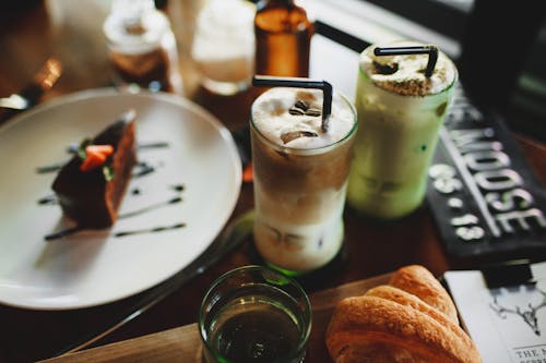 Delicious assorted milkshakes placed on table with chocolate dessert