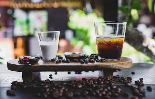 Free Glass of cold coffee served with milk and beans Stock Photo