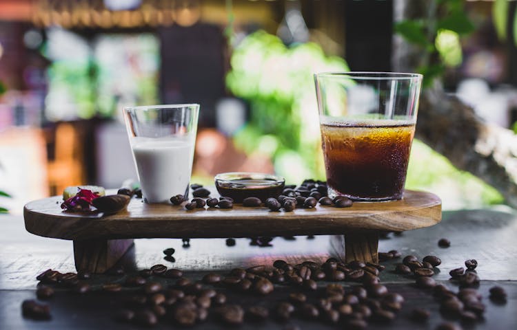 Glass Of Cold Coffee Served With Milk And Beans