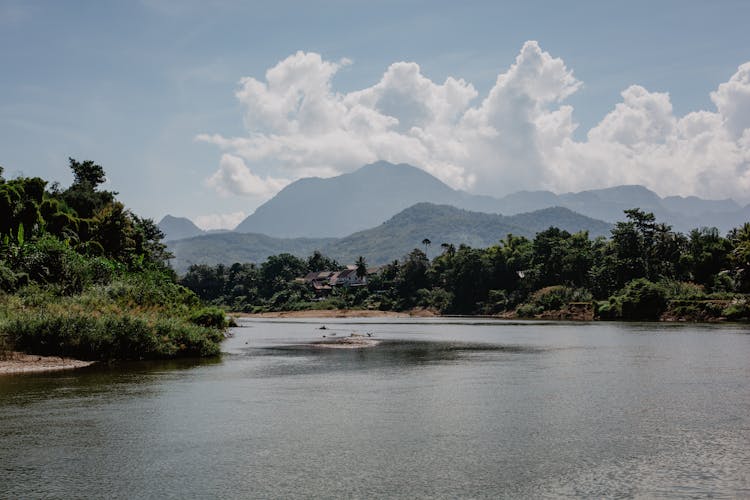 Mountain Lake And Tropical Forest Against Blue Sky