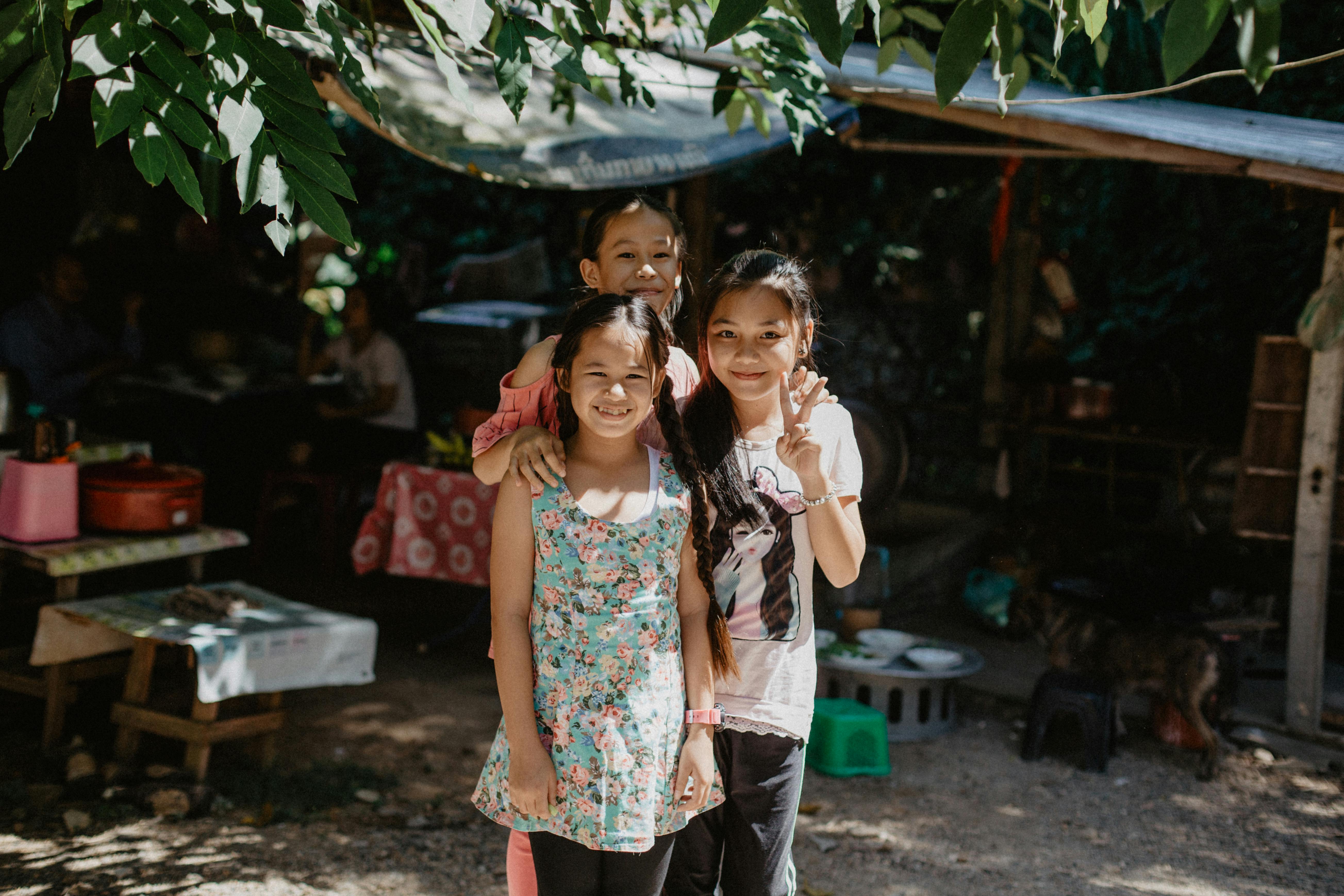 cheerful little asian kids spending time on street