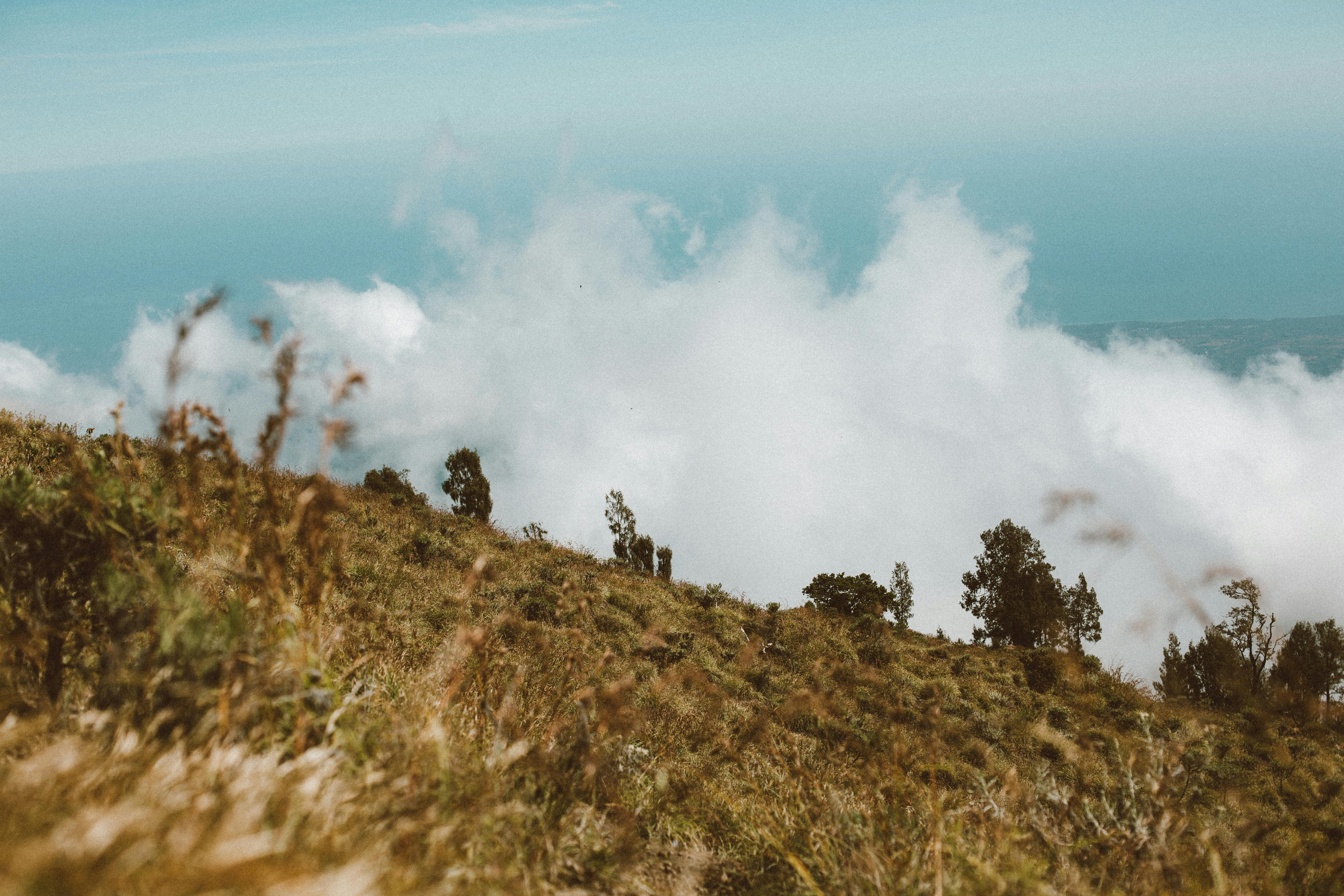 mountain peak in clouds against blue sky