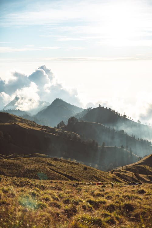 Free Hilly terrain on cloudy day at sunrise Stock Photo