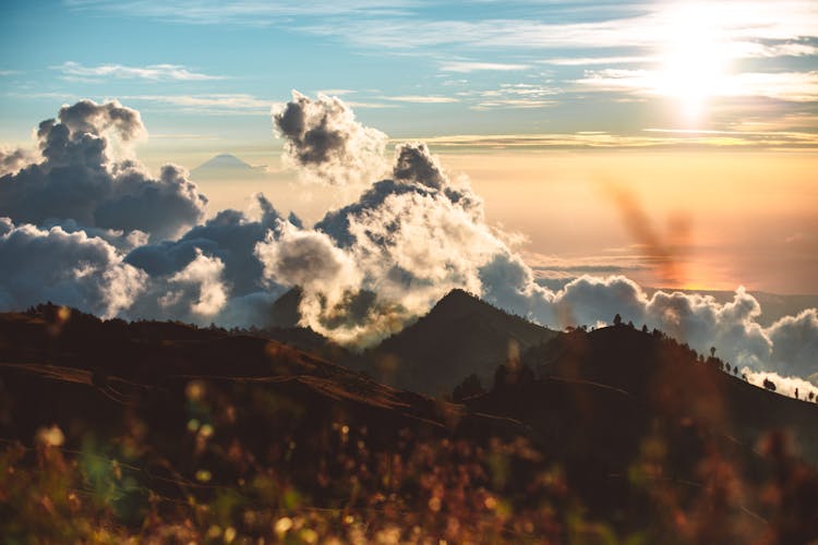 Cloudy Sunset Sky And Hilly Terrain