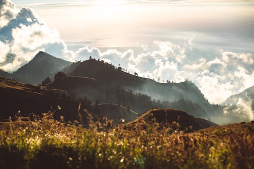 Hills in bright sunshine and clouds at sunset