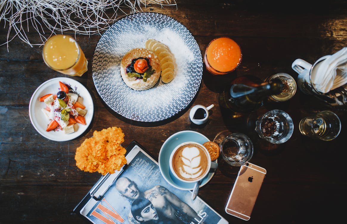 Breakfast consisted of pancakes salad juice and cappuccino