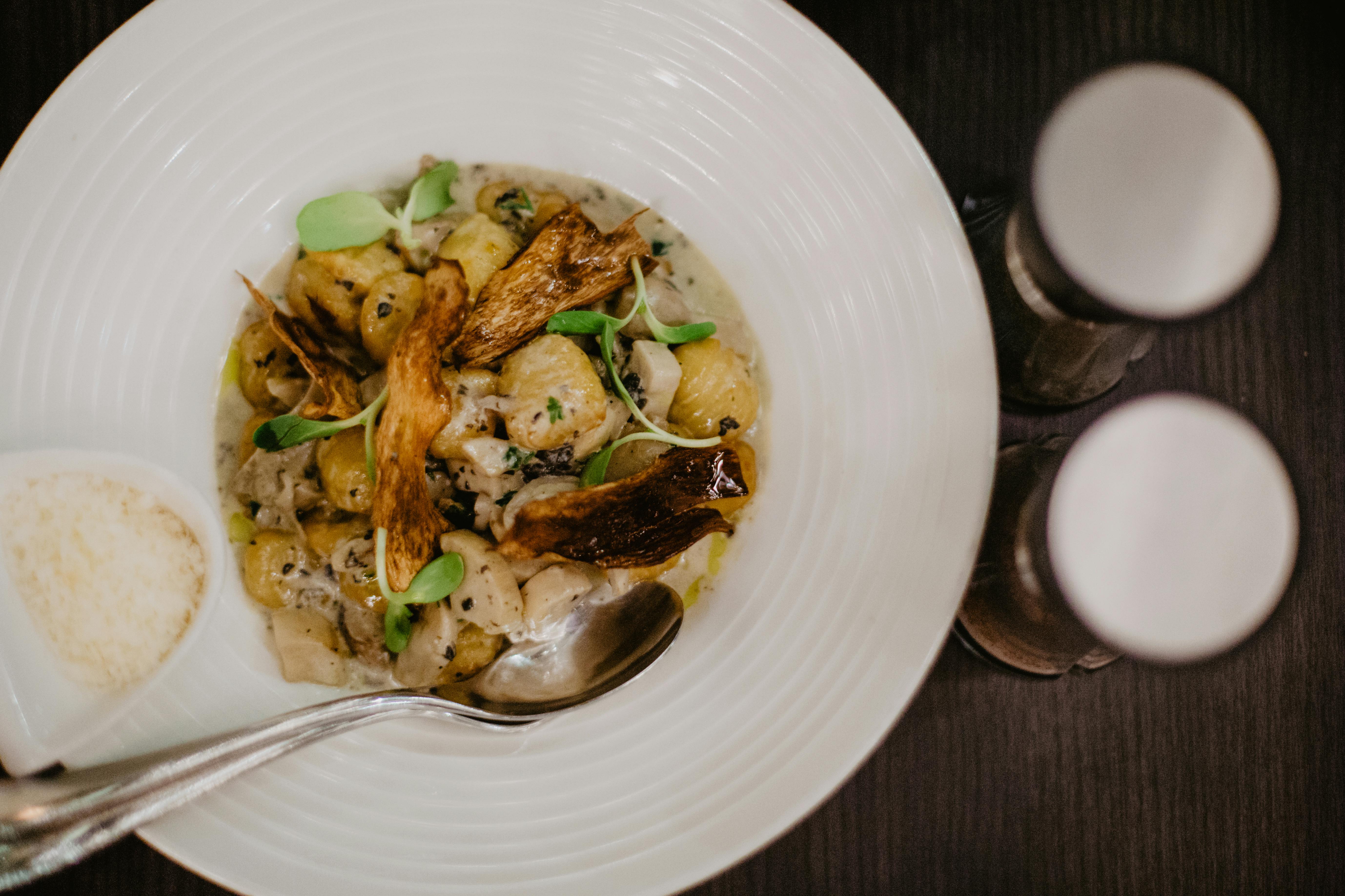 potatoes and mushrooms with chicken in white plate