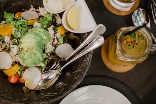 Tasty salad and smoothie on table