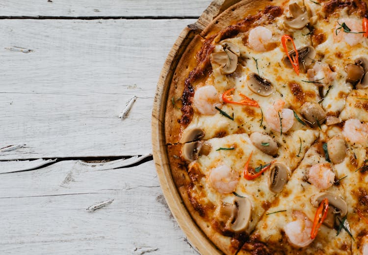 Appetizing Pizza With Shrimps And Champignon On Wooden Table