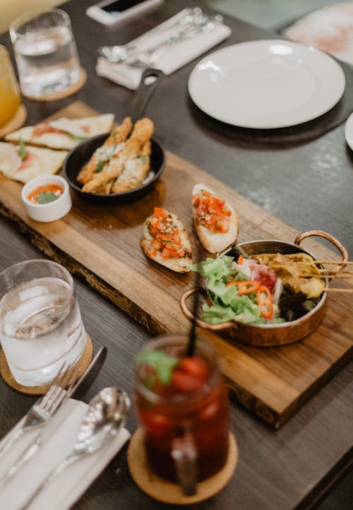 Various meat with sandwiches and drinks on table in cafe