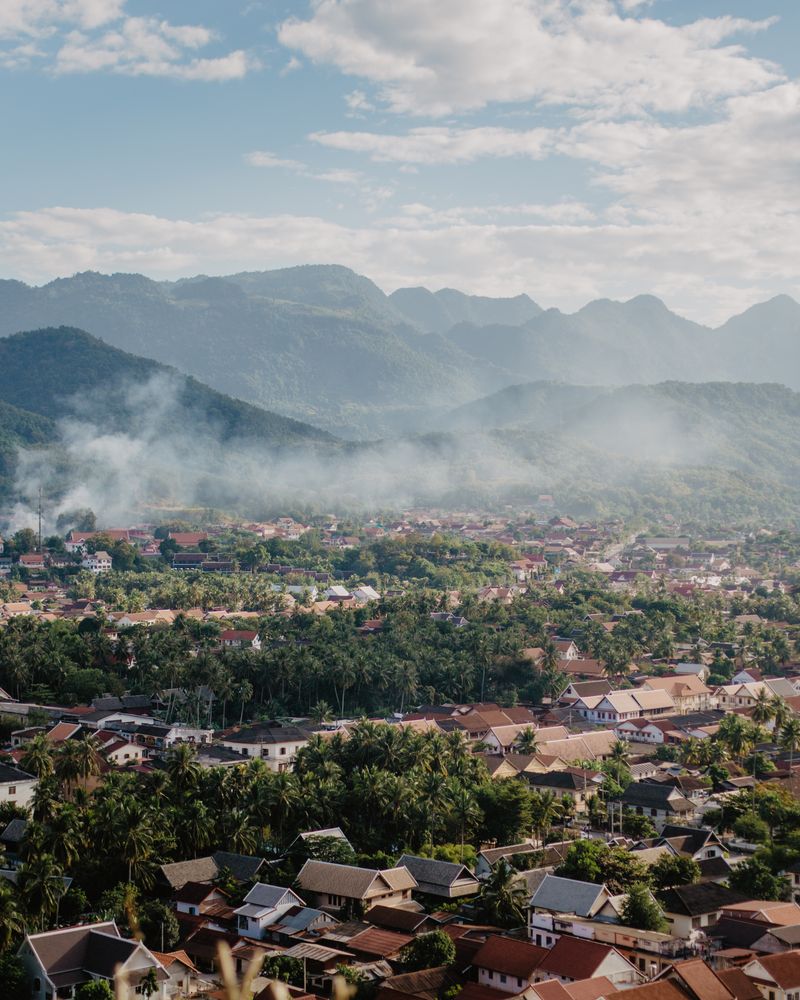 Aerial view of Luang Prabang town surrounded by misty mountains, Laos