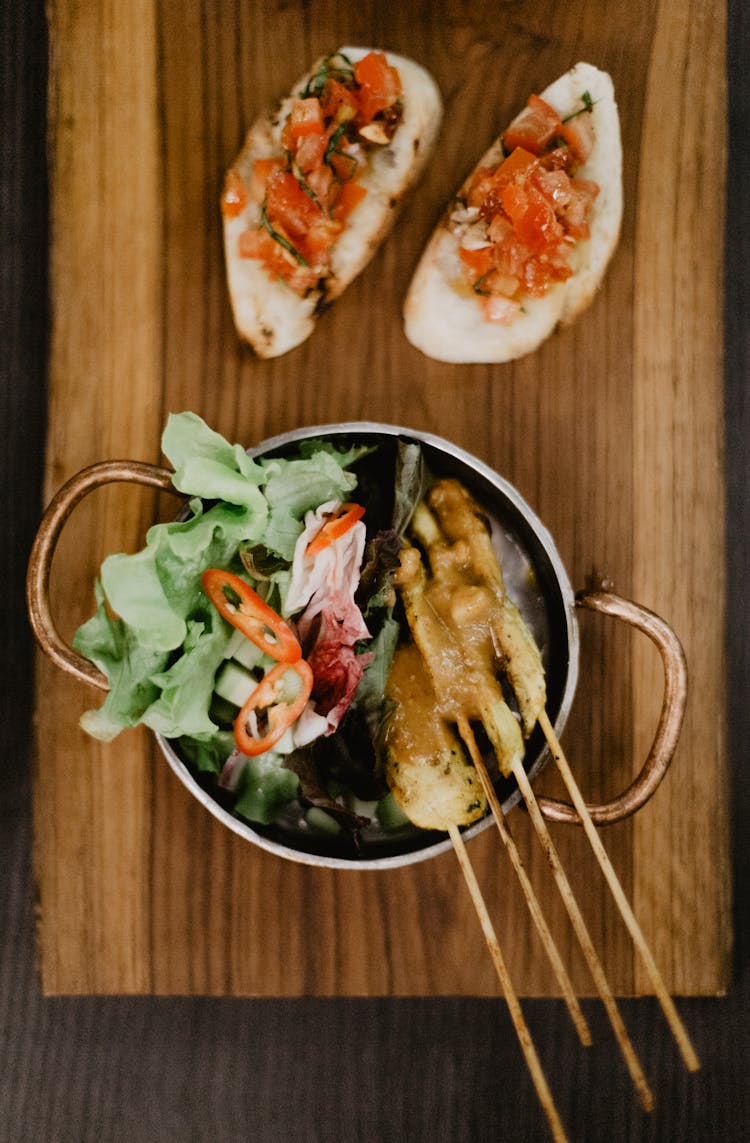 Grilled Meat On Sticks In Pot With Vegetables Near Sandwich