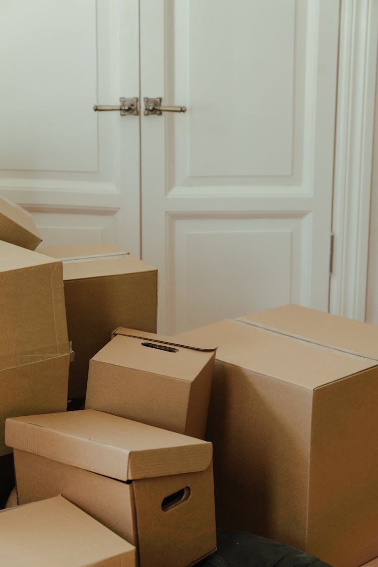 Brown Cardboard Box On White Wooden Door