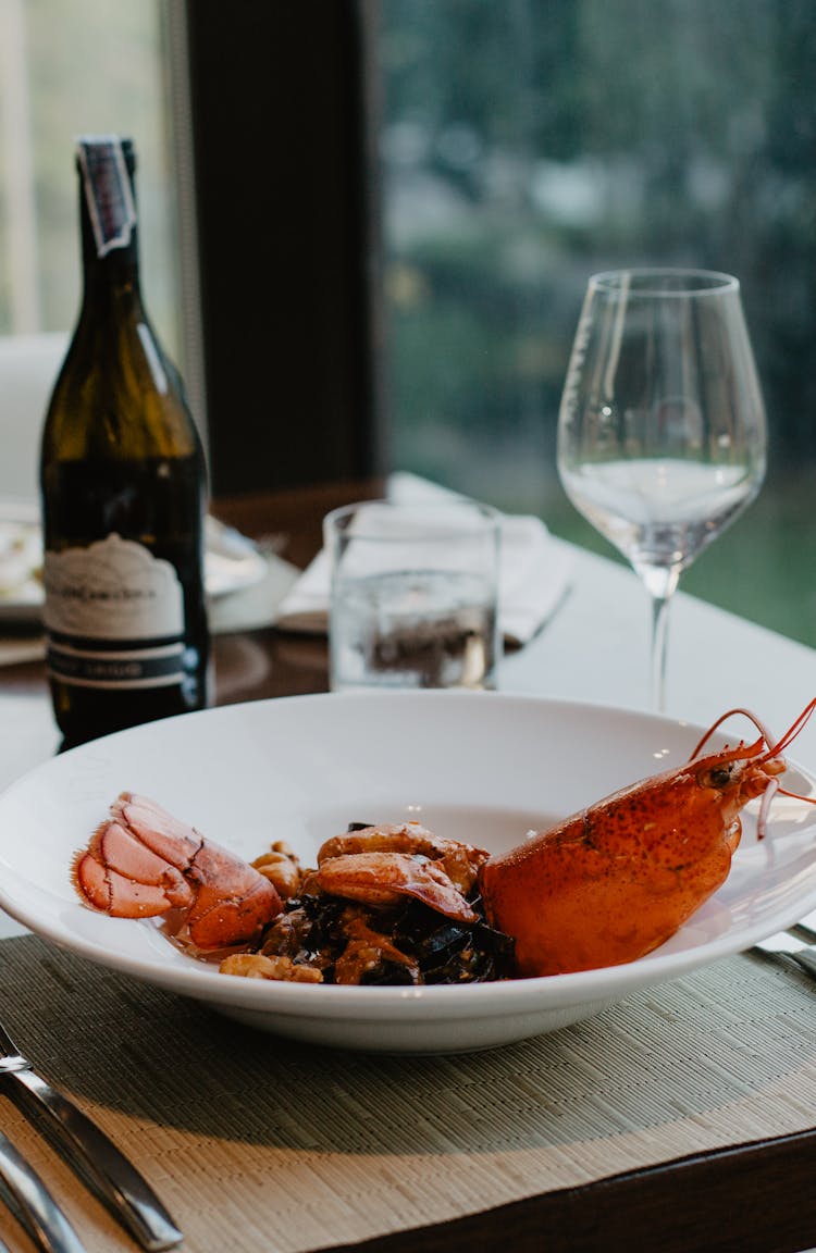 Boiled Lobster Served On White Plate With Wine