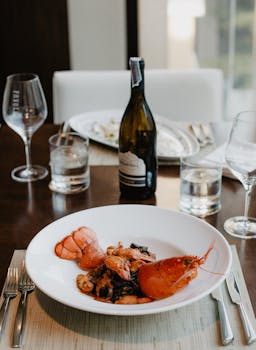 Tasty boiled organic lobster served on plate with white wine and water in fancy restaurant