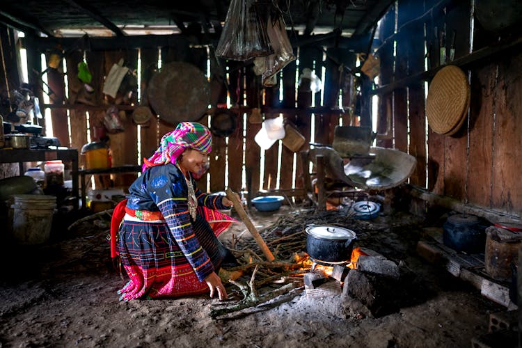 Adult Woman Cooking Over Fire