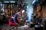 Focused woman cooking on fire