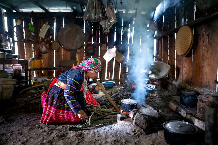 Focused Woman Cooking On Fire