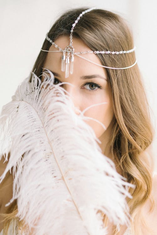 White Feather near Woman's Face