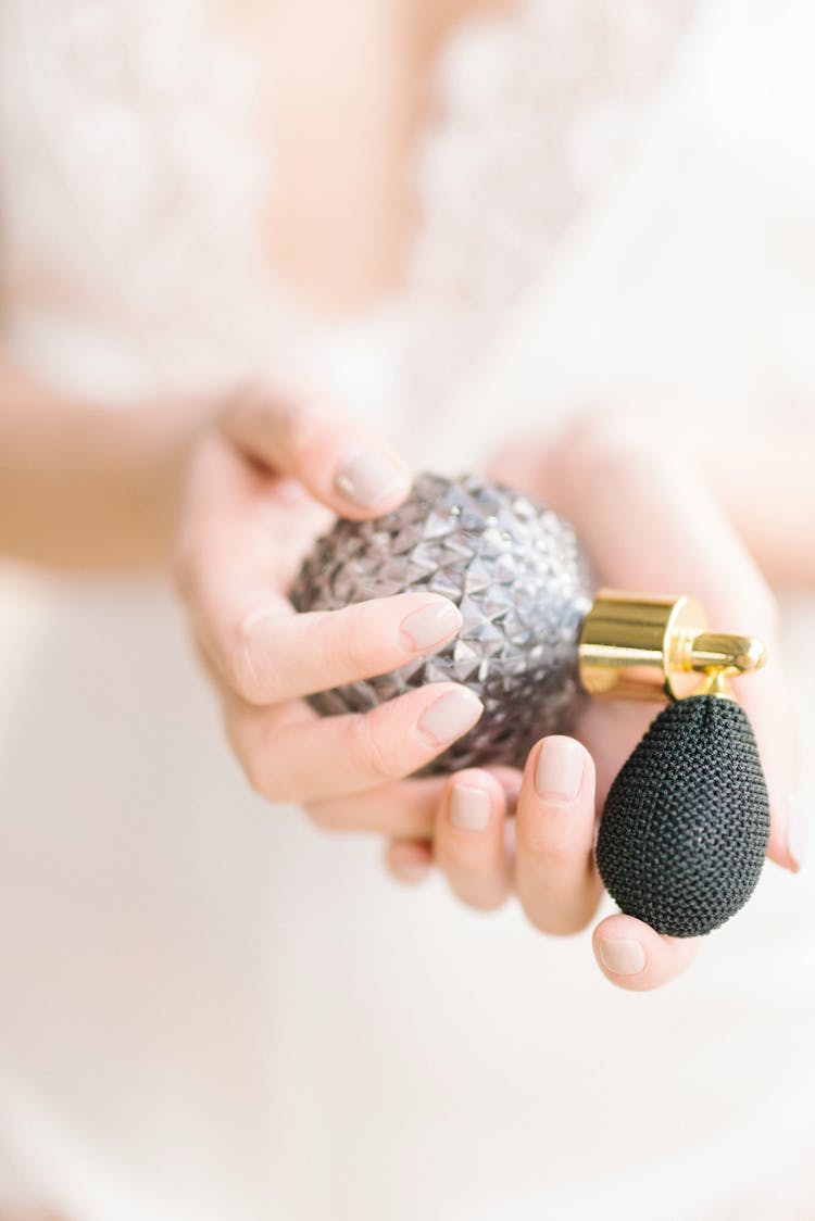 Hands Holding A Vintage Perfume Bottle 