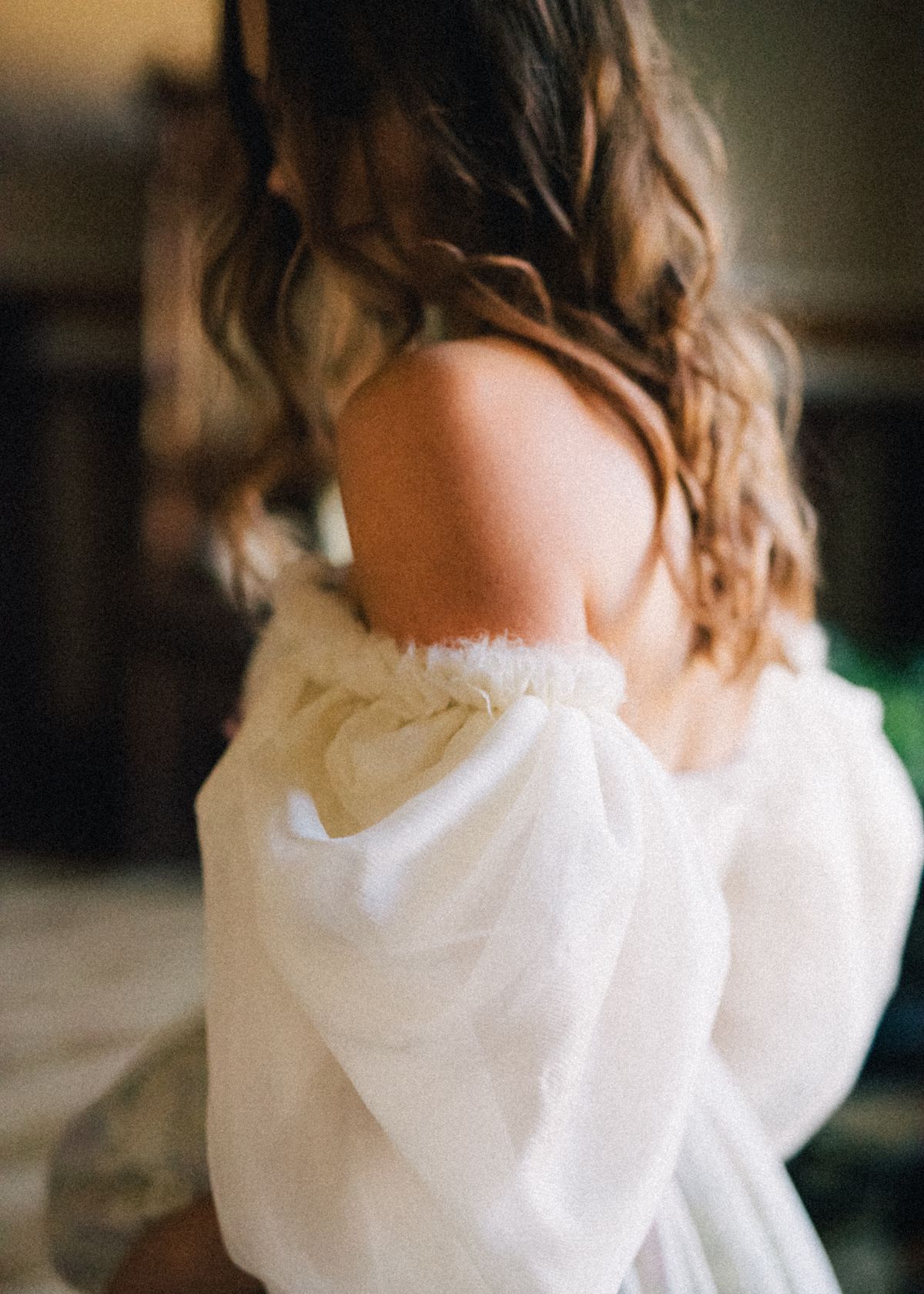 A woman in a white off-shoulder dress — soft, feminine, romantic