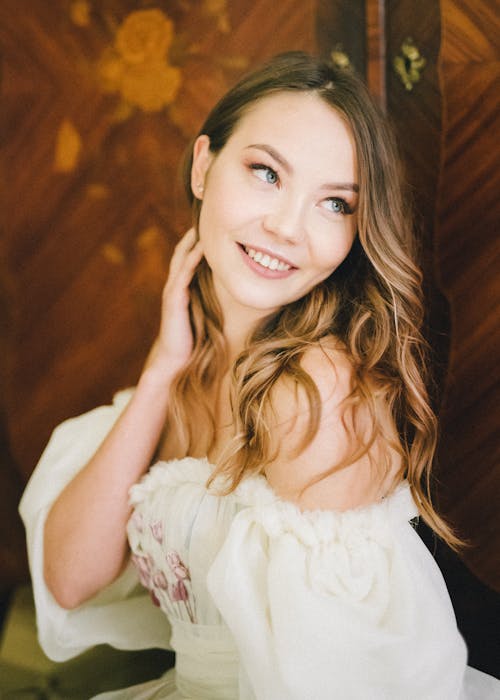 Brunette Woman Posing While Touching Her Hair 