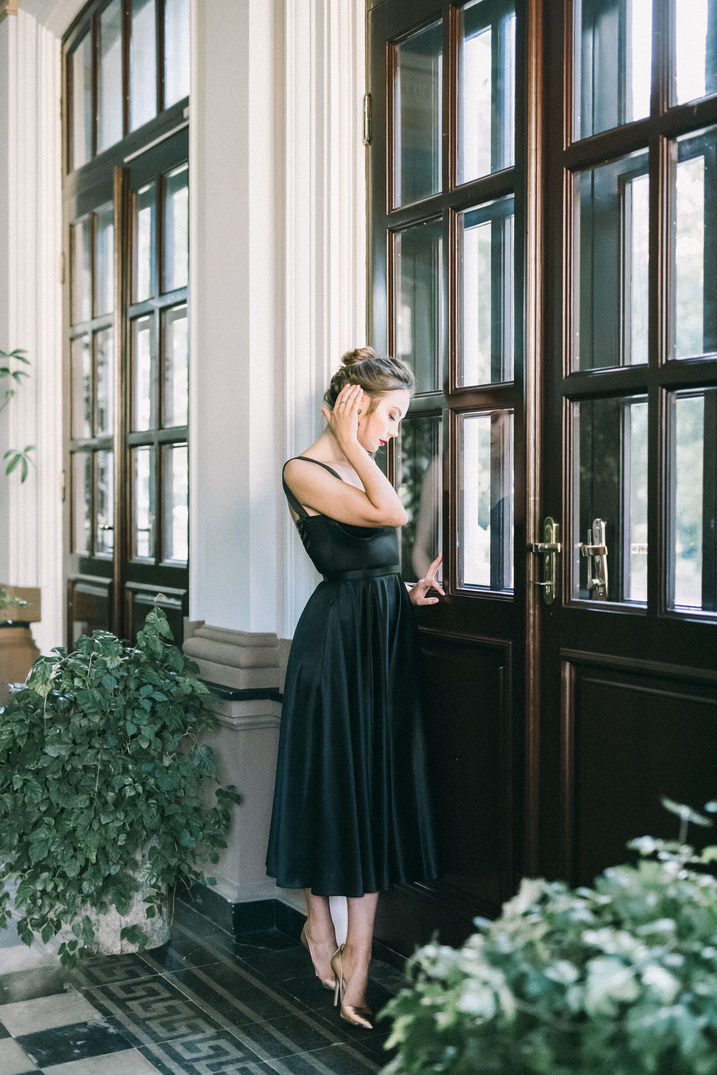 A Woman in Black Dress Standing near Door · Free Stock Photo