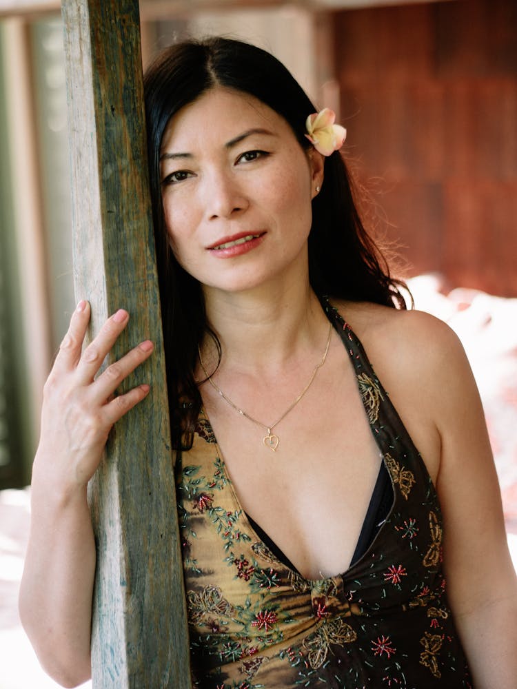 Young Ethnic Woman In Trendy Clothes Leaning On Column