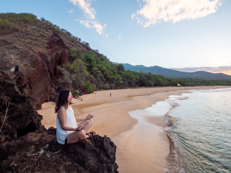 Young Ethnic Woman Meditate On Empty Beach