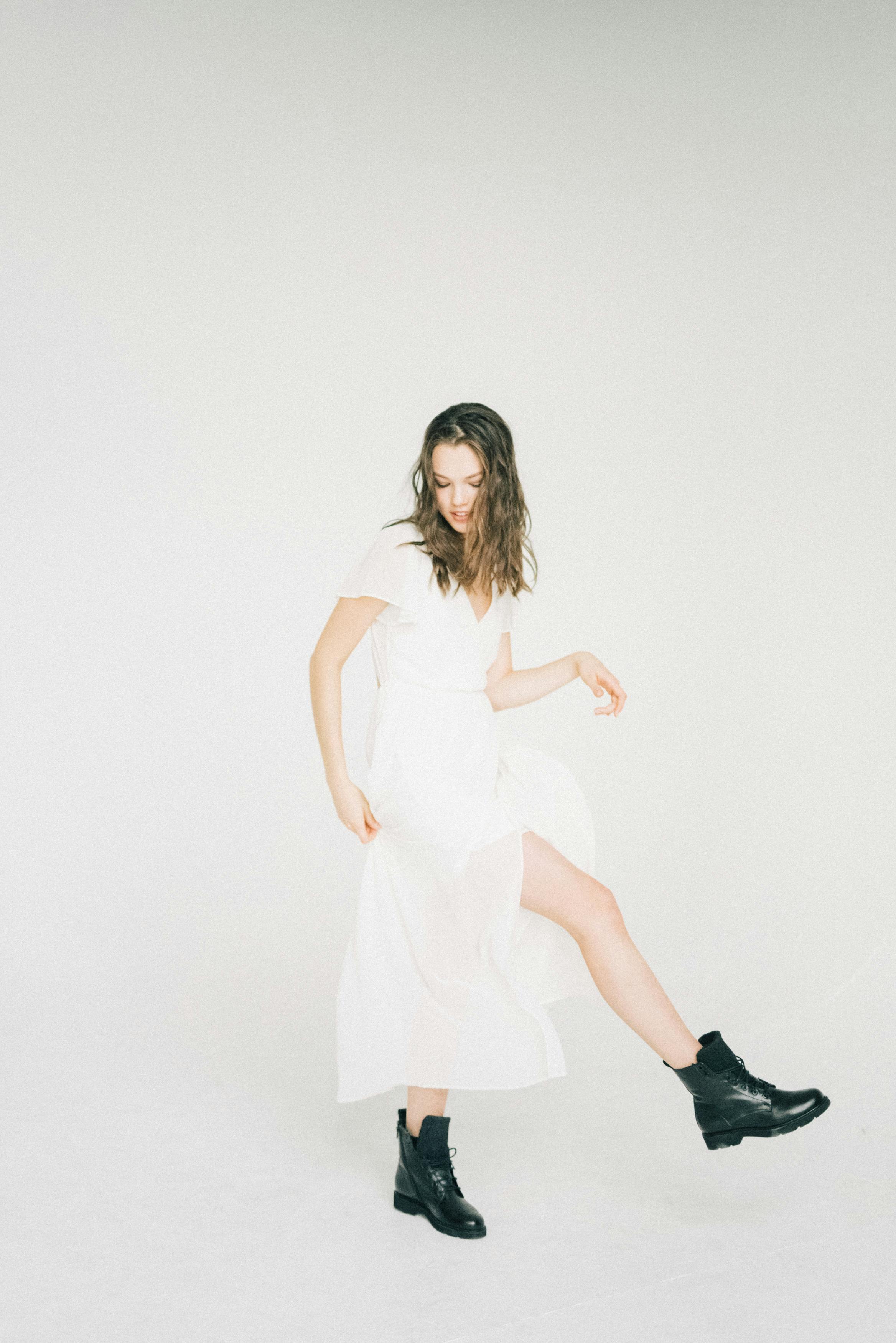 woman in white dress and black boots